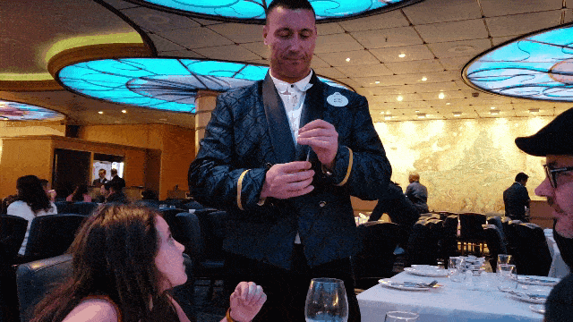 Waiter on Disney Cruise shares paper flower with child