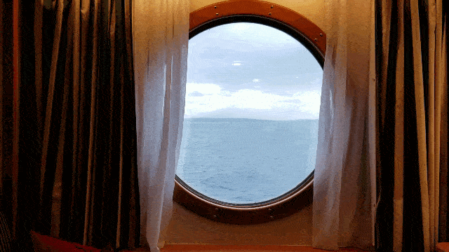 View of ocean from porthole in stateroom on Disney Wonder