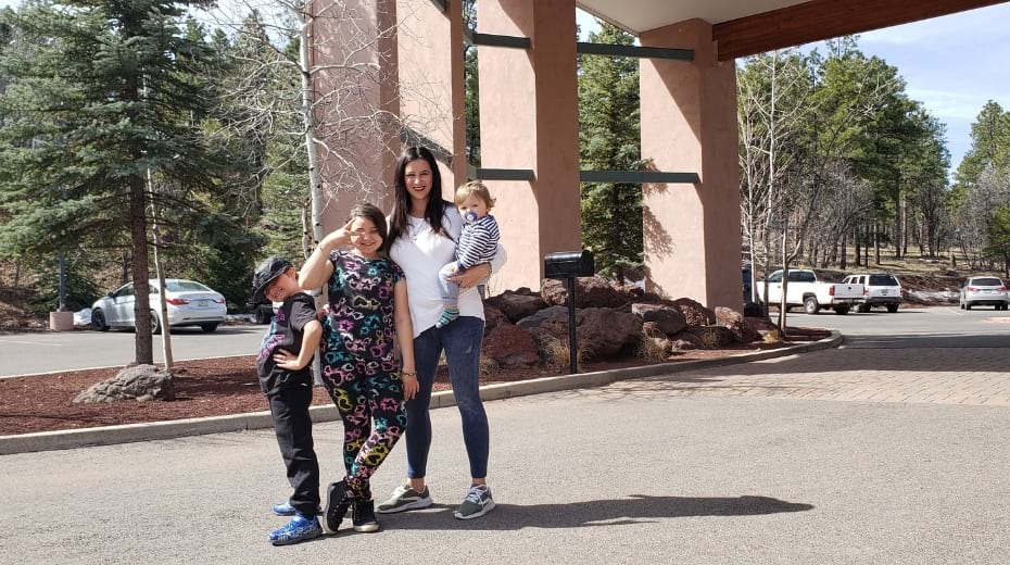 Family posing outside Best Western Plus Inn of Williams